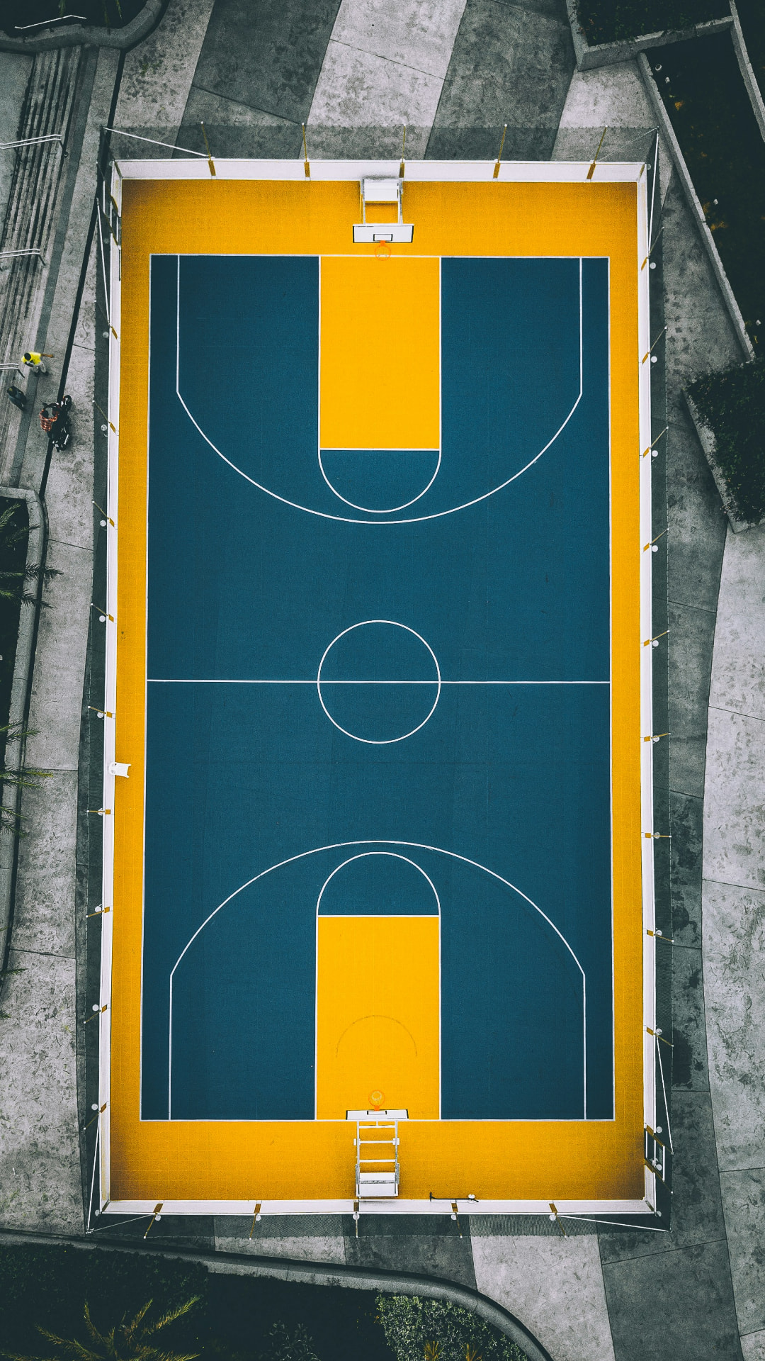 An empty outdoor basketball court seen from above